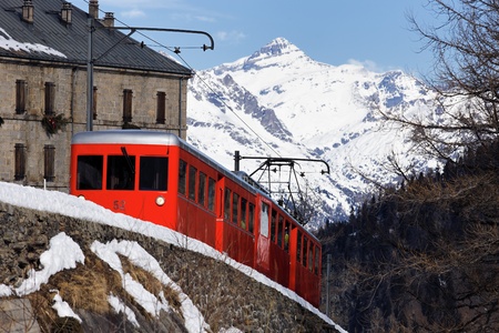 red train in french alpine mountain in winterの写真素材