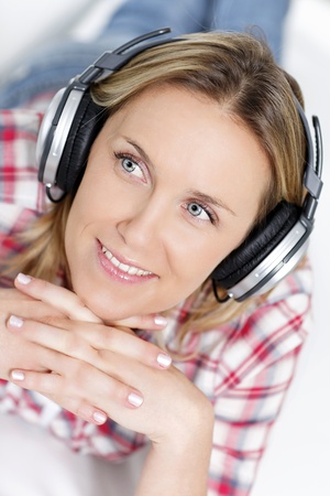 beautiful blond woman listening music with headphoneの写真素材