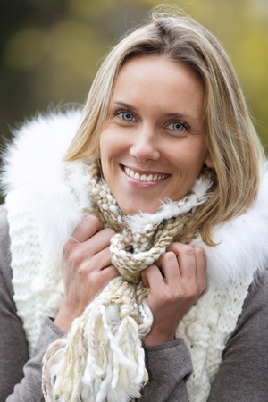 beautiful blond woman smiling outdoor in autumnの写真素材