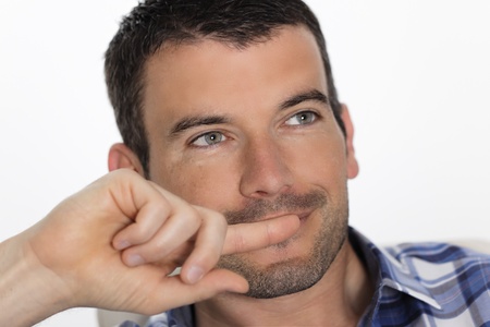 portrait of beautiful man relax on sofa at homeの写真素材