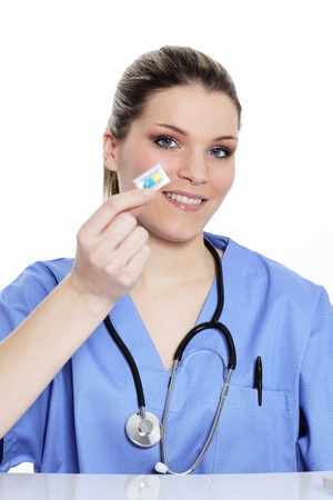 woman doctor holding a pill in hospitalの写真素材