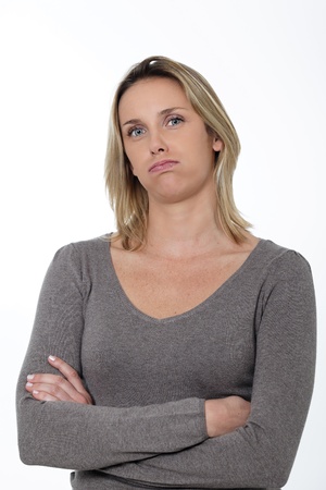 overworked woman in studio with crossed armsの写真素材