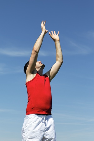 goal raising hand to heaven to catch the ballの写真素材