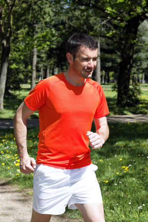 man running in a park in springの写真素材