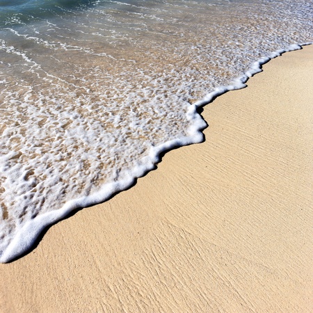 part of mexican beach with wave on the sandの写真素材