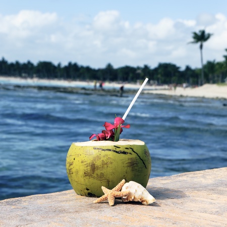 Coconut cocktail with drinking straw on a beach in Mexicoの写真素材