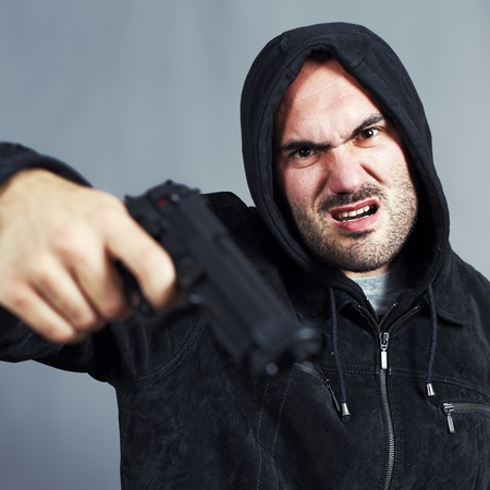 very bad boy with a gun in the handの写真素材