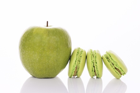 green apple with macaroons on white backgroundの写真素材