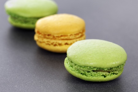 three green and yellow macaroons in kitchenの写真素材