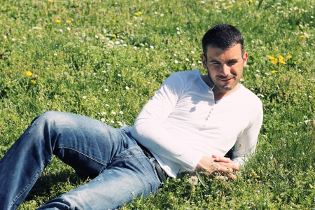 handsome man on the grass in a parkの写真素材