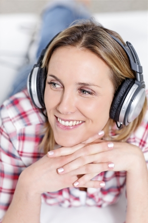 youngblond woman listening music with headphonesの写真素材