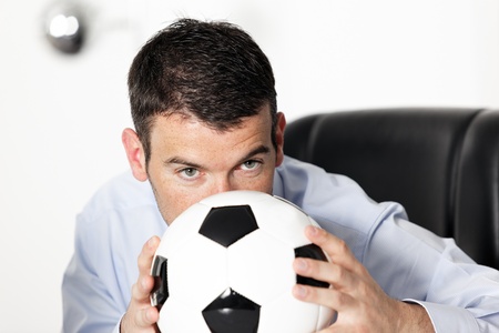 young businessman in office with ballの写真素材