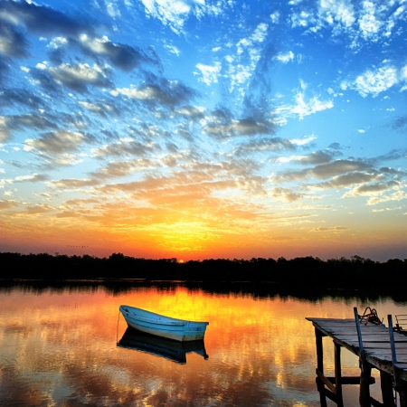little boat on the lake in sunsetの写真素材