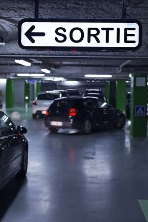 Underground parking with cars and exit signのeditorial素材