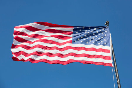 American flag on the blue sky, USA.