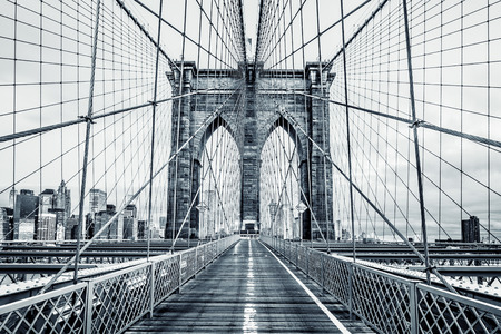 New York City Brooklyn Bridge in Manhattan closeup with skyscrapers and city skyline over Hudson River. Black and white.の写真素材