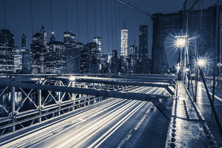 On Brooklyn Bridge at night with car traffic, NY, USA.の写真素材