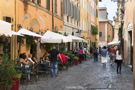 ROME, ITALY - MAY 27, 2016: Tourists and restaurants on a street in the city center.のeditorial素材