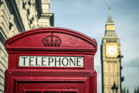 iconic british old red telephone box with the Big Ben at background in the center of Londonの写真素材