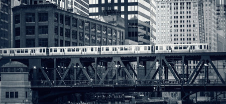 Black and white view of elevated railway train in Chicago, USA.