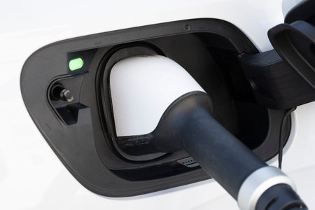 white electric car charging at a stationの写真素材