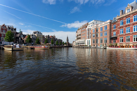AMSTERDAM, NETHERLANDS - AUGUST 23 2022, Famous cityscape with boat in Amsterdamのeditorial素材