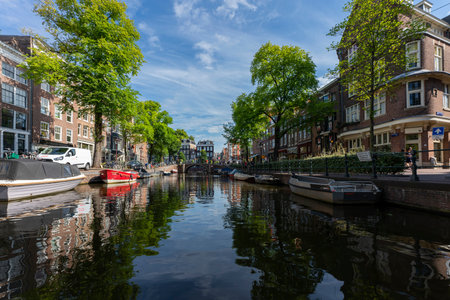 AMSTERDAM, NETHERLANDS - AUGUST 23 2022, Famous cityscape with boat in Amsterdamのeditorial素材