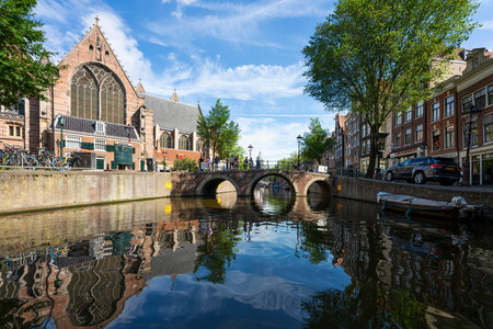 AMSTERDAM, NETHERLANDS - AUGUST 23 2022, Famous cityscape with boat in Amsterdamのeditorial素材