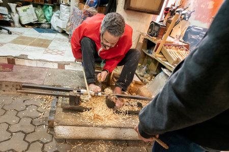 MARRAKECH, MOROCCO - DECEMBER 20, 2022: craftsman working in famous Marrakesh souk in Marrakesh, Morocco.のeditorial素材