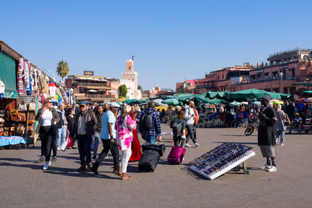 MARRAKECH, MOROCCO - DECEMBER 23, 2022: People walking in famous Marrakesh square Jemaa el Fna in Marrakesh, Morocco. The square is part of the UNESCO World Heritage.のeditorial素材