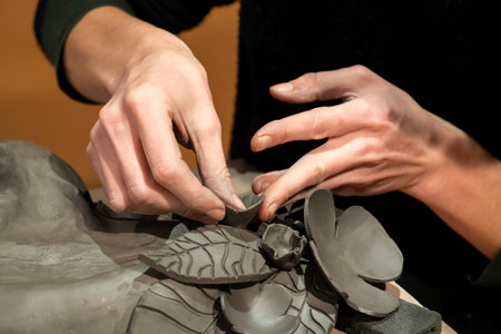 potter woman hands at work in workshop in Franceの写真素材