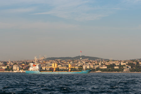 Istanbul Turkey May 7, 2022 A oil tanker ship cruises in Bosporus strait, Asia side coastal landscape on backgroundの写真素材
