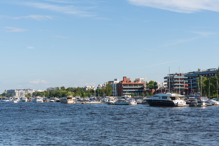 Panoramic summer cityscape, Moored yachts at the yacht club on Krestovsky Island, view of new residential areas of St. Petersburg, Russia. High quality photoの写真素材