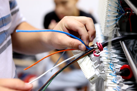 Telecommunications engineer connects the equipment to the cable
