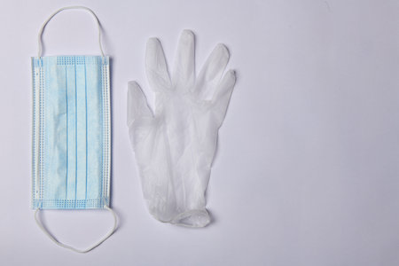 photo of a blue medical mask and gloves