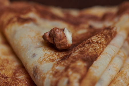 pancakes close-up with nuts lying next to them