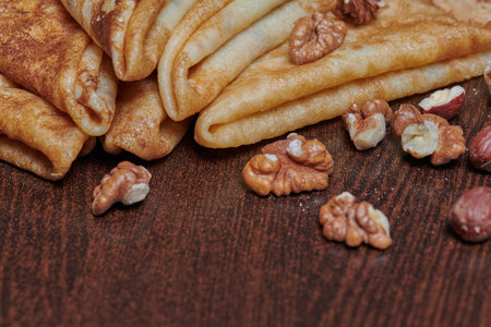 pancakes close-up with nuts lying next to them