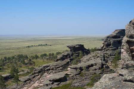 The top of a mountain range against the background of fields and forests