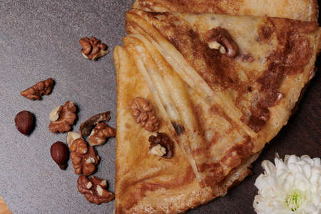 pancakes close-up with nuts lying next to themの写真素材