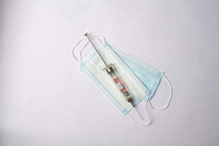 medical syringes coronavirus vaccine medical masks on white backgroundの写真素材