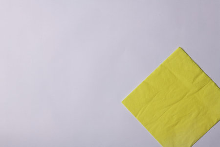 yellow paper napkin lies on a white background