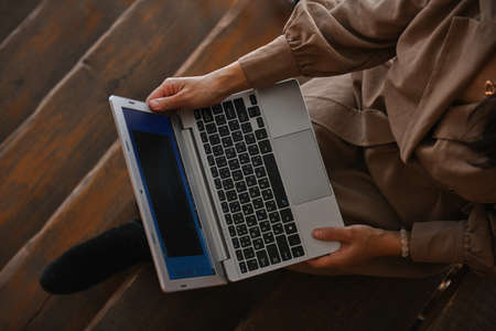 girl in brown dress working on laptopの写真素材