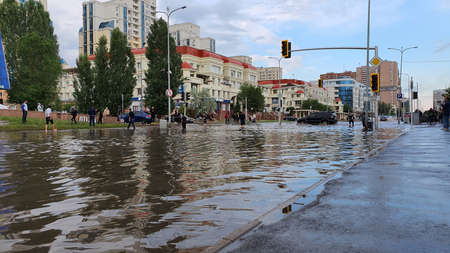 flooded city streets after heavy rain people in waterの写真素材