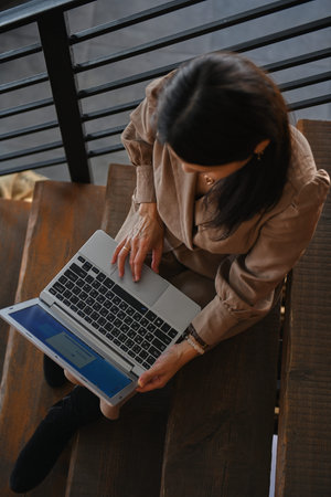 top view of girl working on laptop