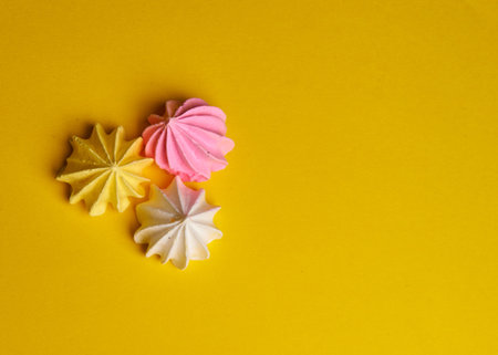 several meringues lie on a yellow background