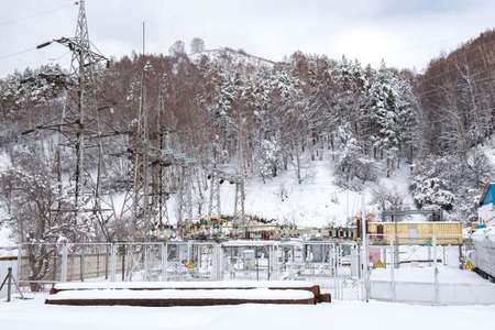 power plant in the mountains covered with snowの写真素材
