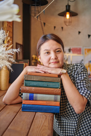 girl in a cafe with books tired of work