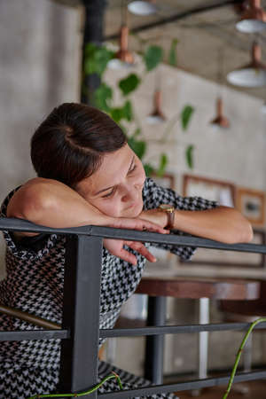 Asian girl in a cafe on the fenceの写真素材