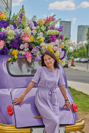 lilac bright car with flowers and a girl