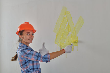 very cool painter paints the wall yellow